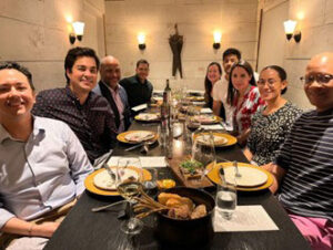 Alumni in NYC gathered around a table for dinner and conversation