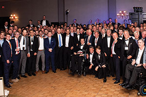 Image of brothers posed for a photo at the 150th anniversary gala. 