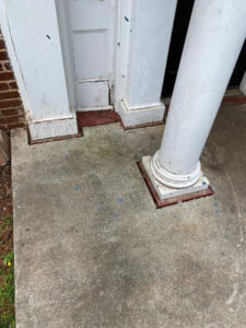 image of front column of Theta Chi house in need of repair