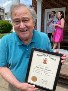 Jim Johnston ('67) with a framed copy of Willie Anderson's Membership Certificate
